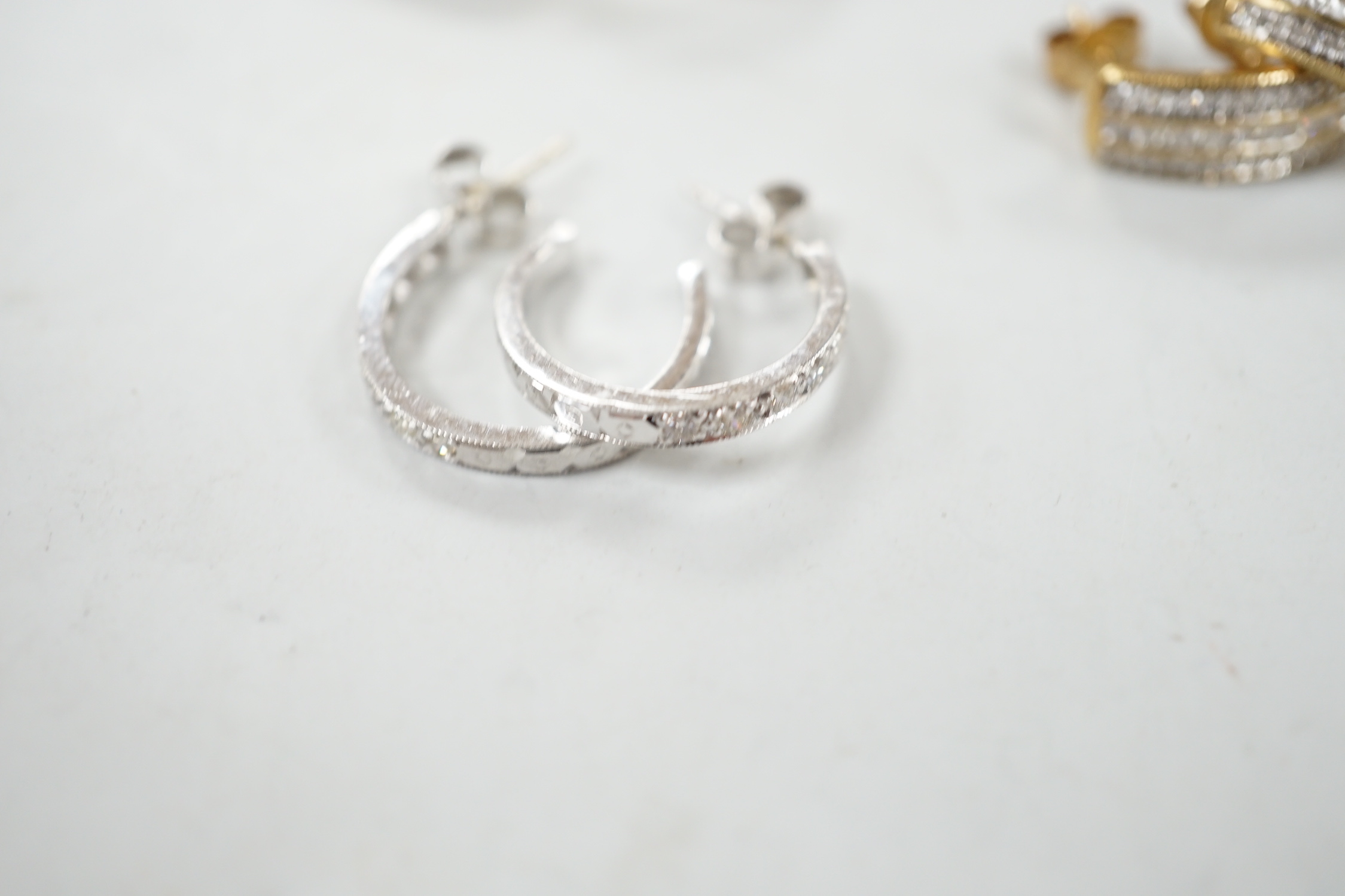 Two modern pairs of 9ct hoop or half hoop earrings and two pairs of 9ct and diamond chip set earrings including white gold, gross weight 10.9 grams.